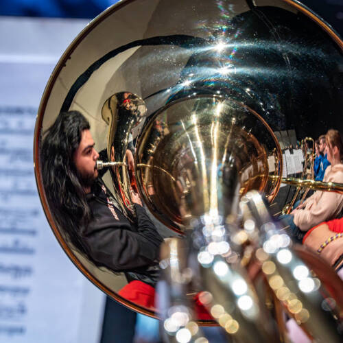 Grand Valley Symphony Orchestra students Jorge Gonzalez and Elizabeth Phillips are reflected in the bell of Matthew Keith’s trombone during a rehearsal for Joel Schut’s MUS 103 class at the Louis Armstrong Theatre on February 23.